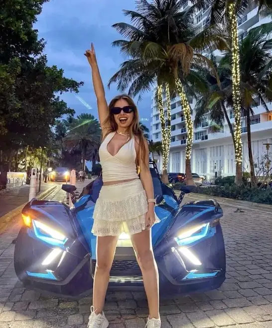 Black Polaris Slingshot rental Miami โ couple enjoying the ride