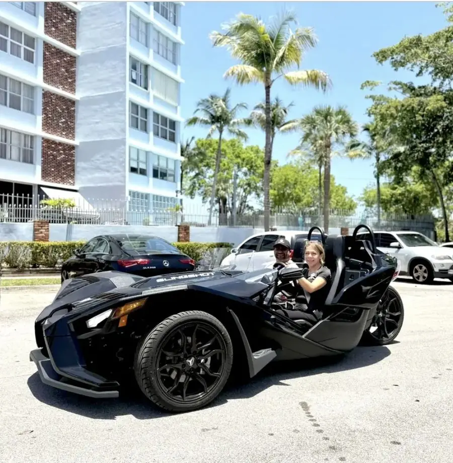Black Polaris Slingshot parked on Miami Beach street